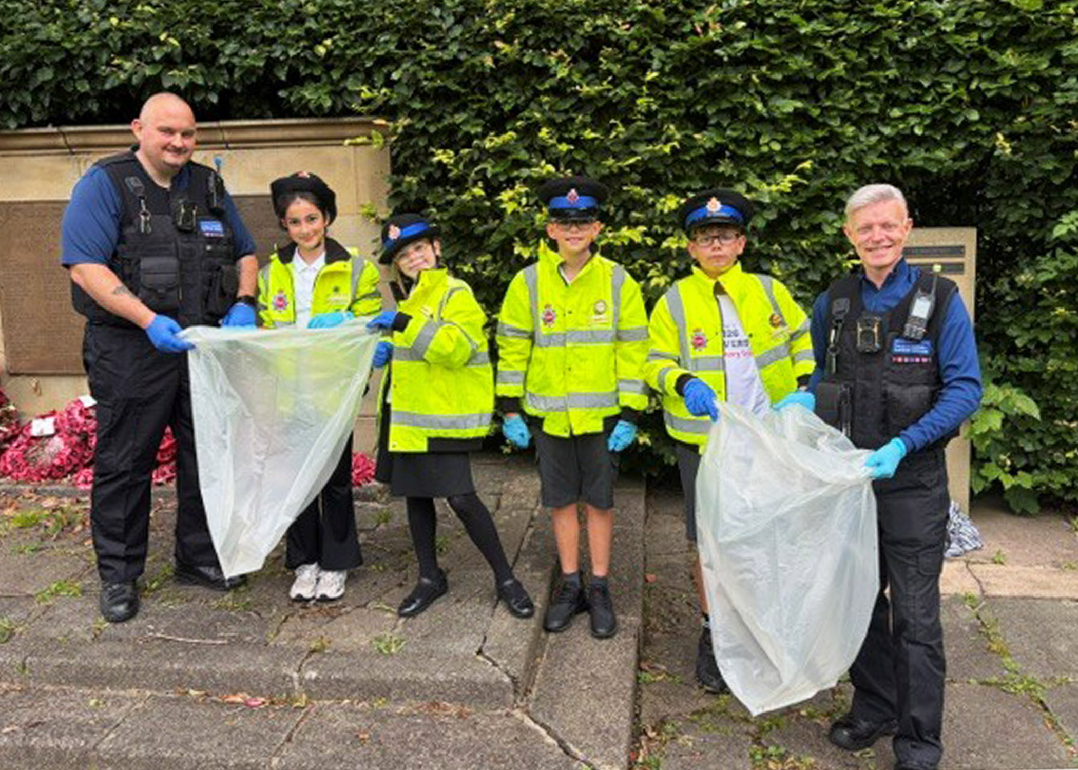 Local junior PCSOs lend a hand to clean a war memorial, and PCSO Mark Fitzgerald is honoured with a plaque at community garden opening anniversary