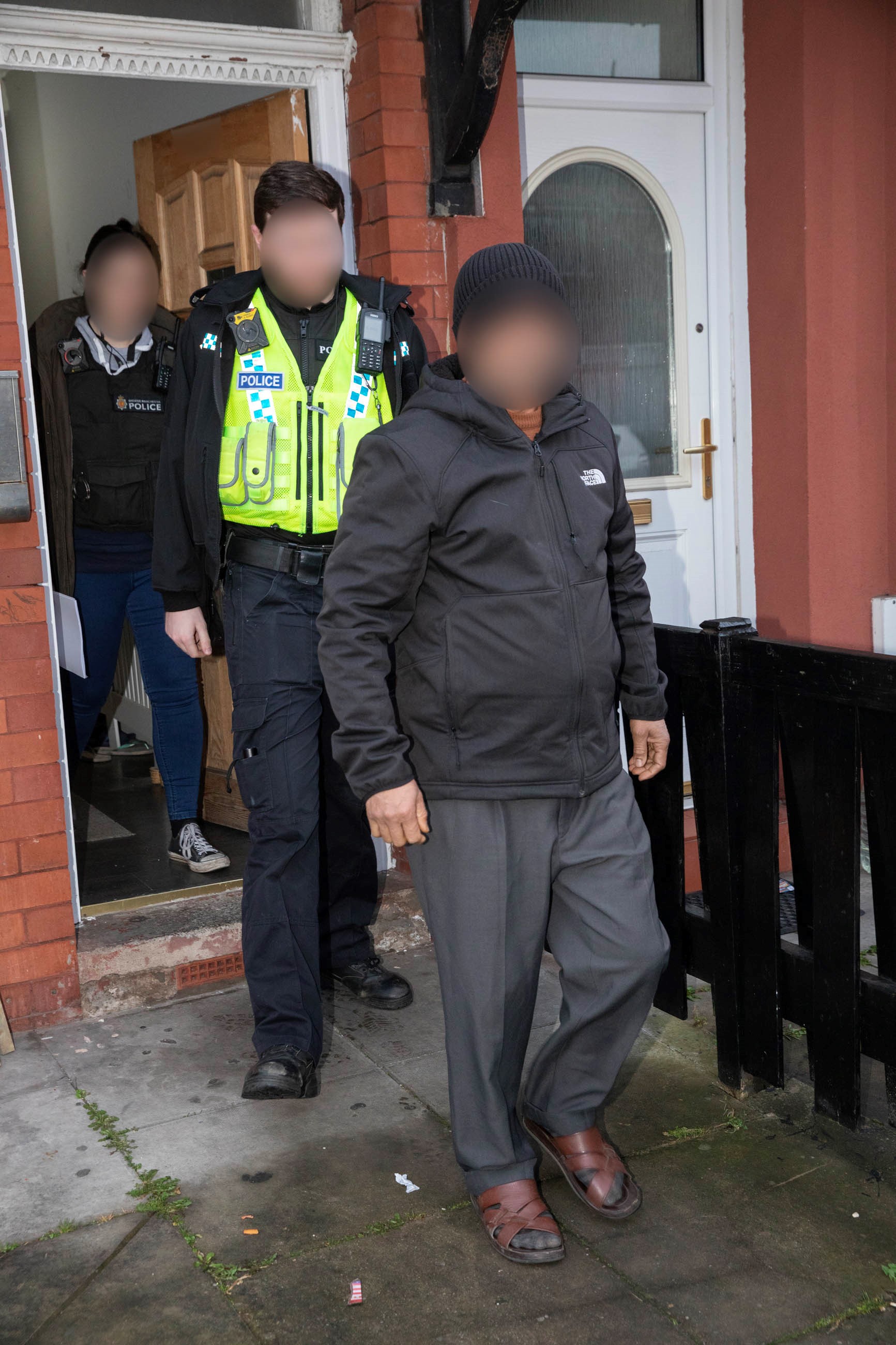 suspect led out of house