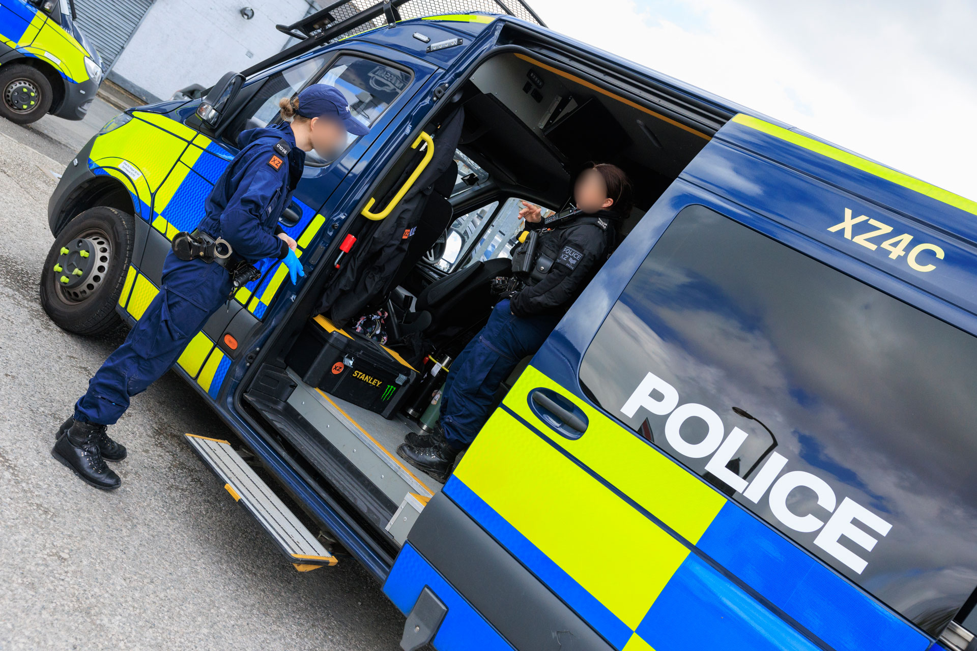 Police officers and TAU van