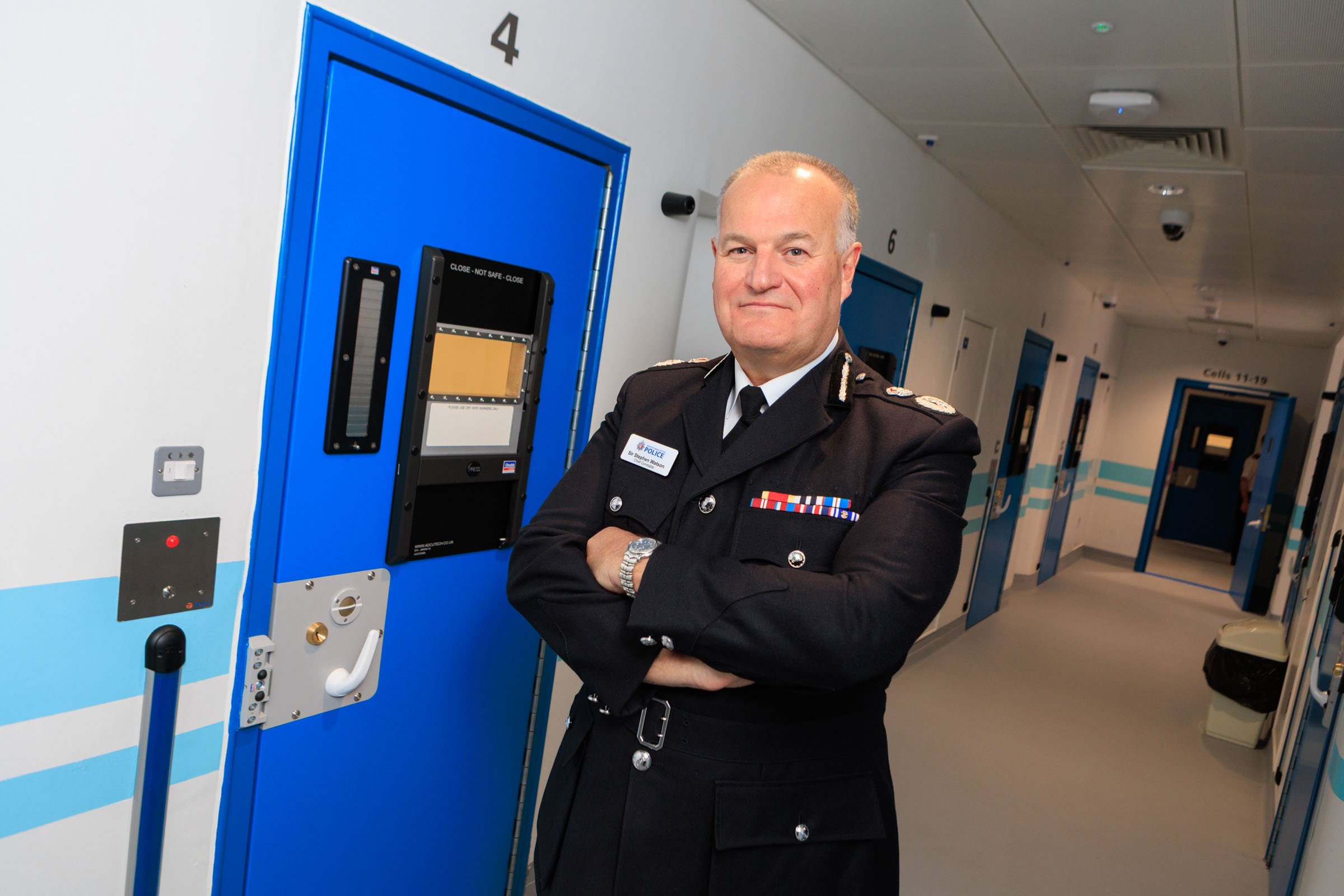 Chief Constable Sir Stephen Watson outside of a police cell at Longsight Custody suite.