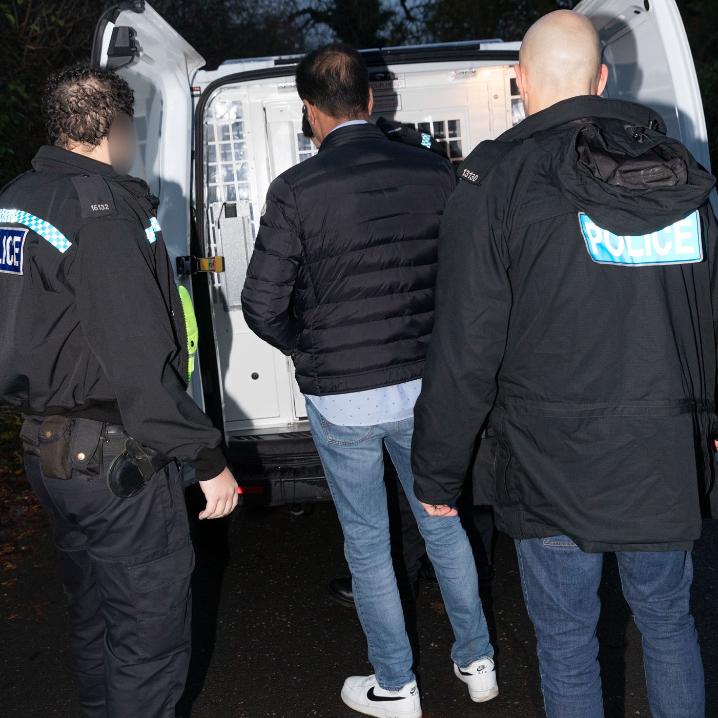 Suspect being taken to custody