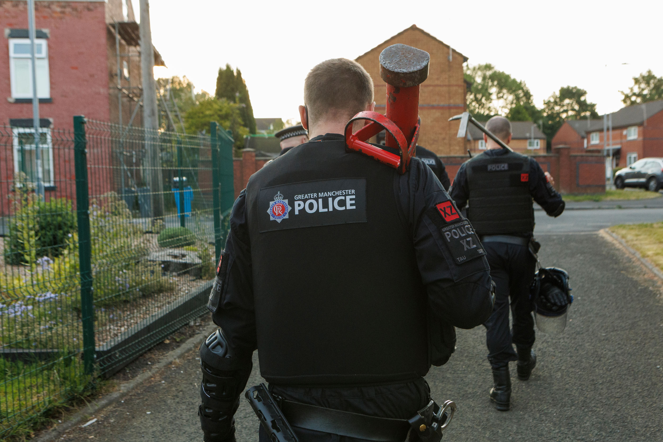 Picture of Greater Manchester Police officer following a warrant being executed in Gorton.
