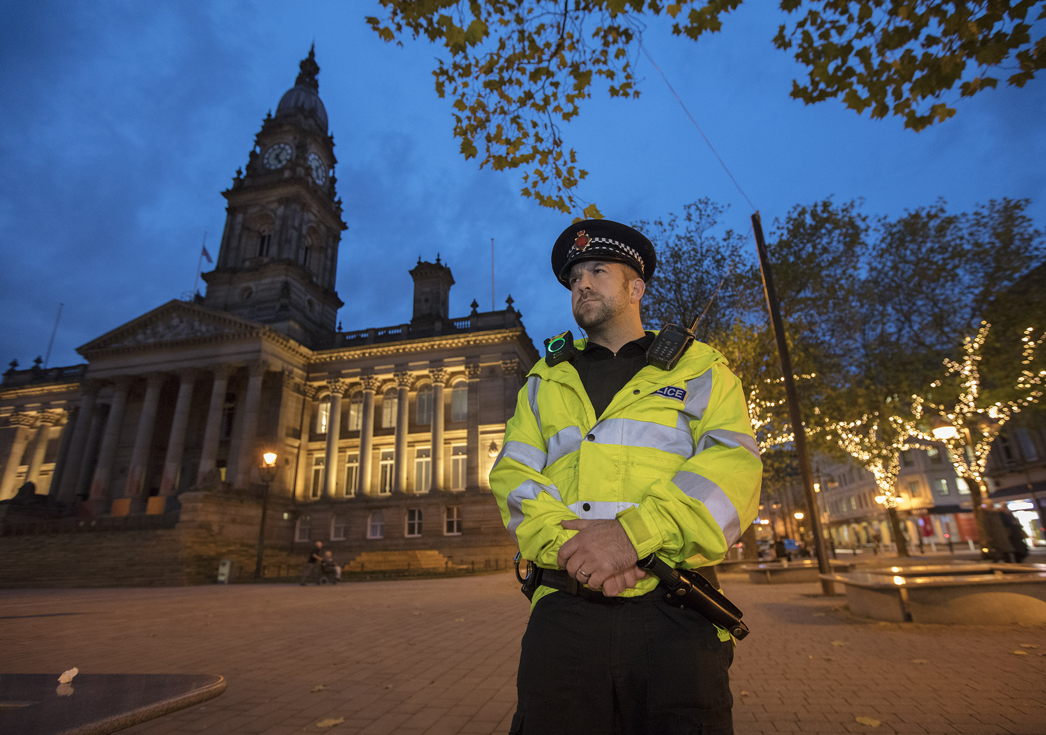 Bolton Town Hall at night with police officer
